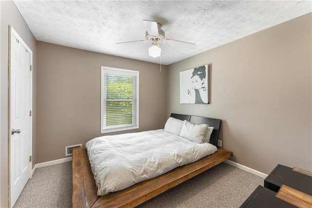 bedroom featuring visible vents, carpet flooring, baseboards, and a ceiling fan