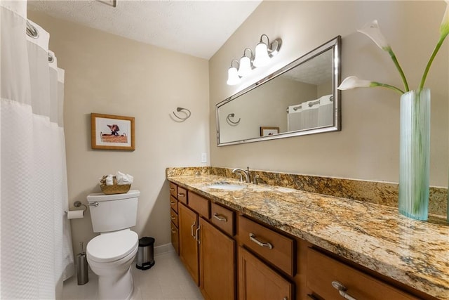 full bathroom featuring vanity, tile patterned flooring, and toilet