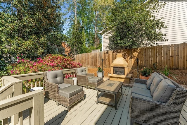 wooden terrace with outdoor lounge area and a fenced backyard