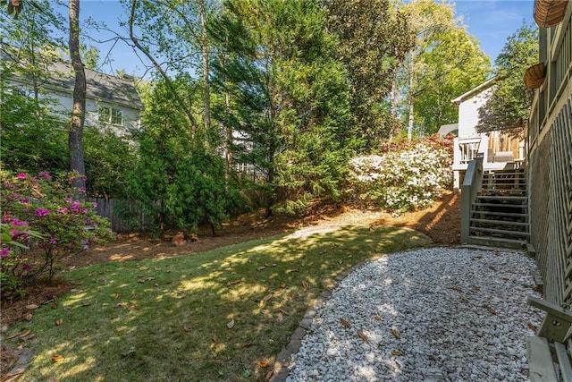 view of yard featuring a wooden deck and stairway