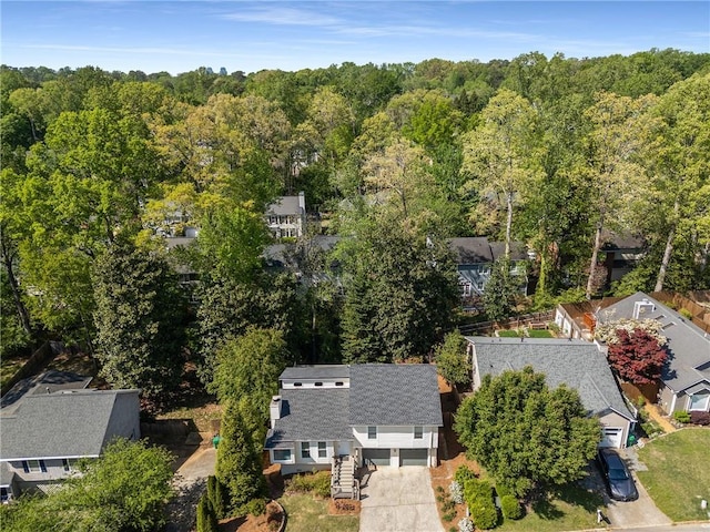 birds eye view of property featuring a view of trees and a residential view