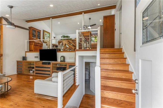 stairway with lofted ceiling with beams, baseboards, recessed lighting, a ceiling fan, and wood finished floors