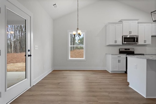 kitchen featuring visible vents, light wood-style floors, appliances with stainless steel finishes, white cabinetry, and a chandelier