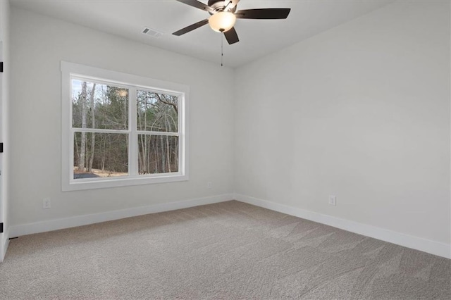 spare room featuring visible vents, ceiling fan, baseboards, and carpet