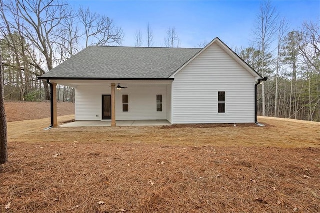 back of house featuring a yard, ceiling fan, a patio, and roof with shingles