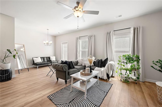 6372 Rosetta Dr SW, Atlanta, GA 30331 - living area with light wood-style floors, ceiling fan, a chandelier, and baseboards