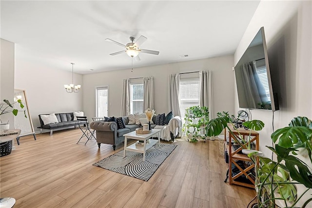 6372 Rosetta Dr SW, Atlanta, GA 30331 - living room featuring ceiling fan, a chandelier, and light wood-type flooring