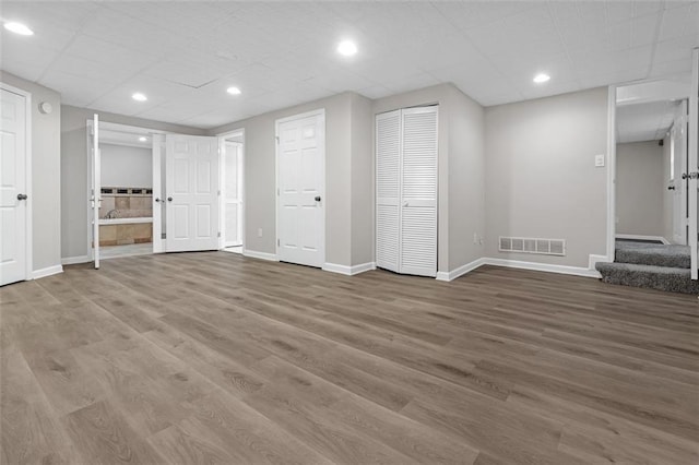 basement with hardwood / wood-style flooring