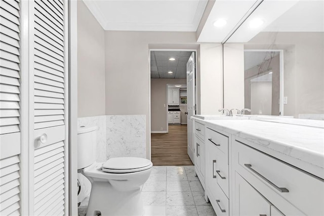 bathroom featuring vanity, toilet, hardwood / wood-style floors, and crown molding