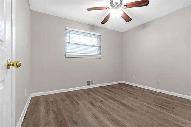 spare room featuring hardwood / wood-style floors and ceiling fan