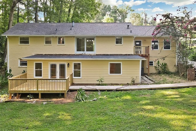 back of house featuring a wooden deck and a yard