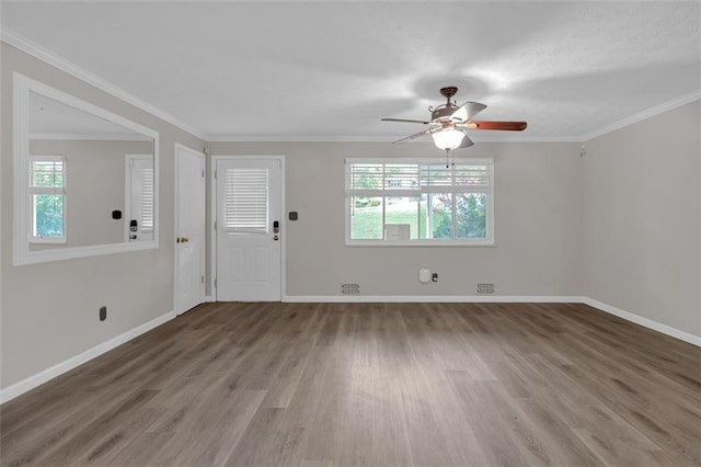 spare room with ceiling fan, ornamental molding, and wood-type flooring