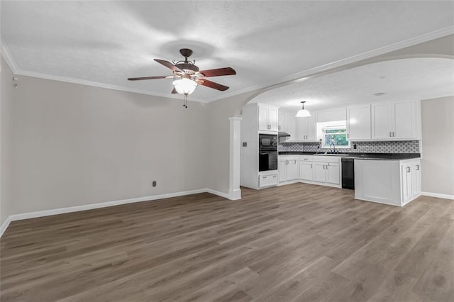 kitchen with ceiling fan, hardwood / wood-style flooring, black appliances, ornamental molding, and sink