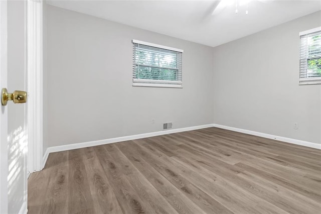 unfurnished room with hardwood / wood-style flooring