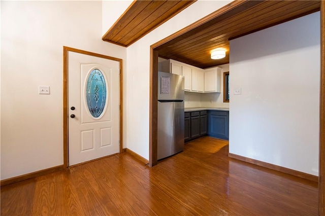 foyer entrance with wooden ceiling and light wood-type flooring