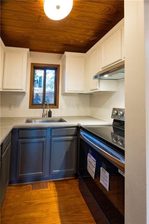 596 Riverview Dr, Ellijay, GA 30540 - kitchen with black range with electric stovetop, a sink, wooden ceiling, under cabinet range hood, and white cabinets