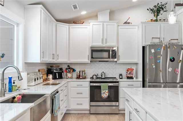 2241 N 16th Hwy, Whitesburg, GA 30185 - kitchen featuring appliances with stainless steel finishes, white cabinetry, backsplash, light stone countertops, and recessed lighting