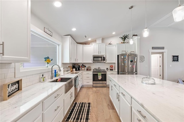 2241 N 16th Hwy, Whitesburg, GA 30185 - kitchen with stainless steel appliances, white cabinetry, backsplash, light wood-type flooring, and light stone counters