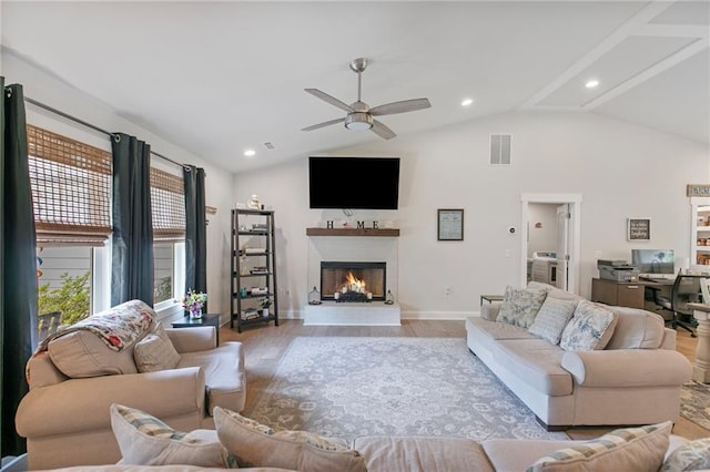 2241 N 16th Hwy, Whitesburg, GA 30185 - living area with vaulted ceiling, a warm lit fireplace, wood finished floors, a ceiling fan, and recessed lighting