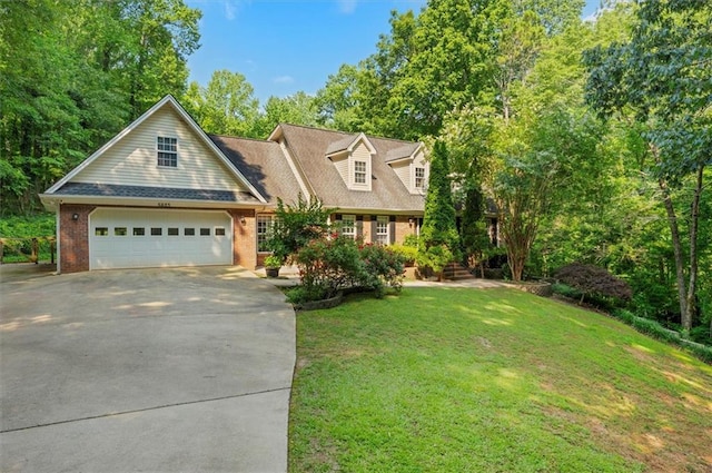 5623 Honeytree Dr, Braselton, GA 30517 - cape cod house featuring concrete driveway, a front yard, an attached garage, and brick siding