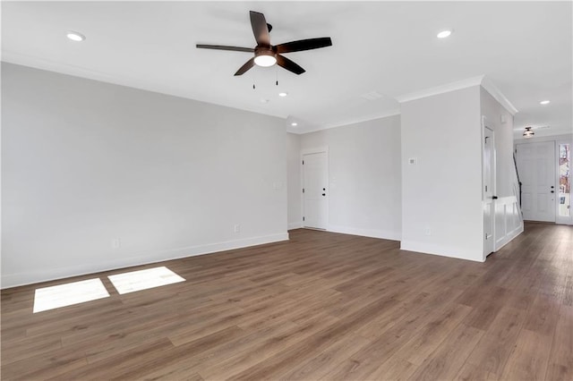 unfurnished living room with crown molding, dark wood finished floors, recessed lighting, ceiling fan, and baseboards