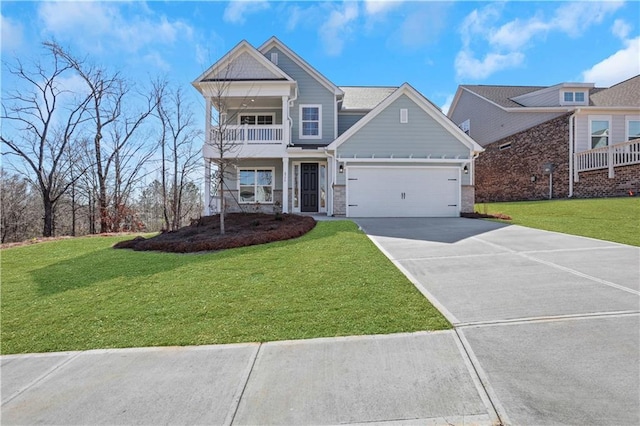 view of front of property with a balcony, an attached garage, a front lawn, and concrete driveway