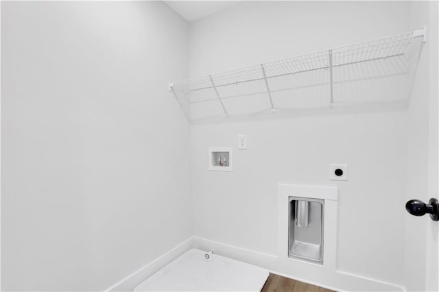 laundry area featuring laundry area, gas dryer hookup, wood finished floors, hookup for an electric dryer, and washer hookup