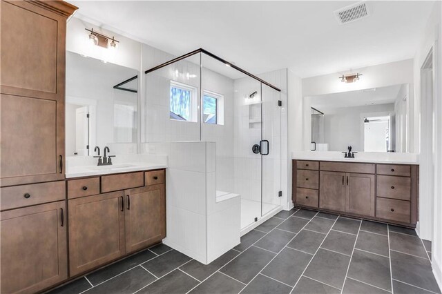 bathroom with two vanities, tile patterned flooring, visible vents, and a sink