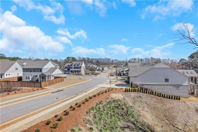 view of road with a residential view, curbs, and sidewalks