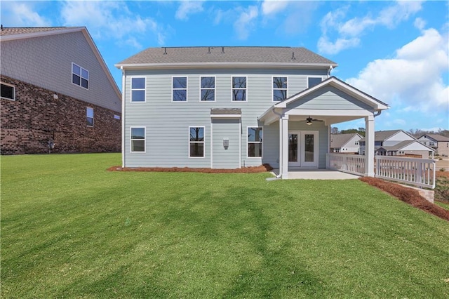 rear view of property featuring a patio area, ceiling fan, fence, and a yard