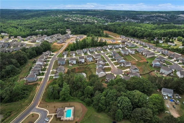 drone / aerial view with a residential view and a wooded view