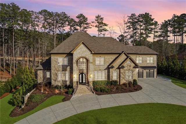 4434 Oglethorpe Loop NW, Acworth, GA 30101 - french country home featuring stone siding, a garage, concrete driveway, french doors, and roof with shingles