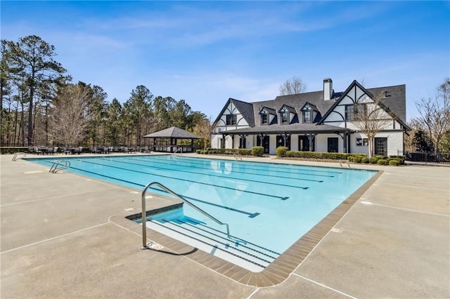 pool featuring a gazebo, a patio area, and fence