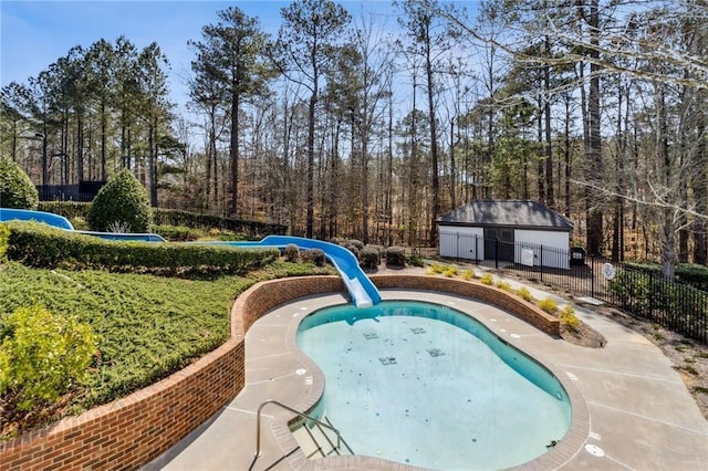 view of swimming pool featuring fence, a fenced in pool, and a water slide