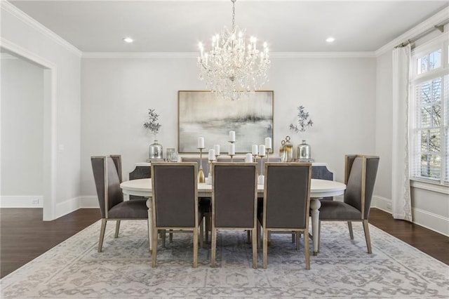 dining room featuring baseboards, a notable chandelier, crown molding, and wood finished floors