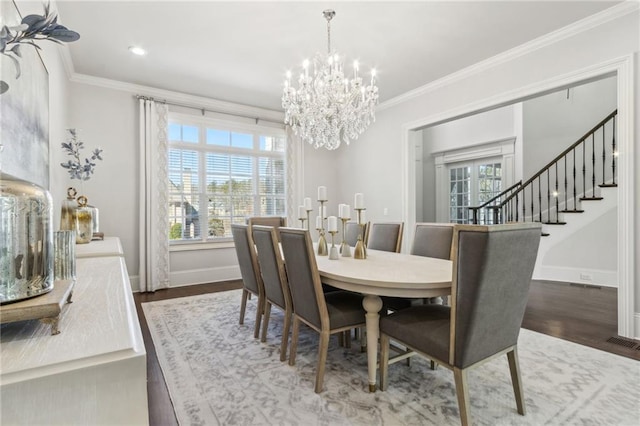 dining space with wood finished floors, baseboards, and a notable chandelier
