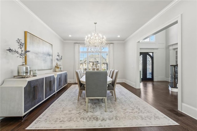 dining area with an inviting chandelier, crown molding, baseboards, and dark wood-style floors