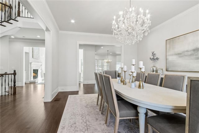 dining space with baseboards, ornamental molding, dark wood finished floors, and an inviting chandelier