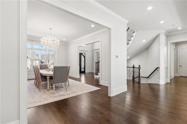 dining space featuring crown molding, wood finished floors, and recessed lighting