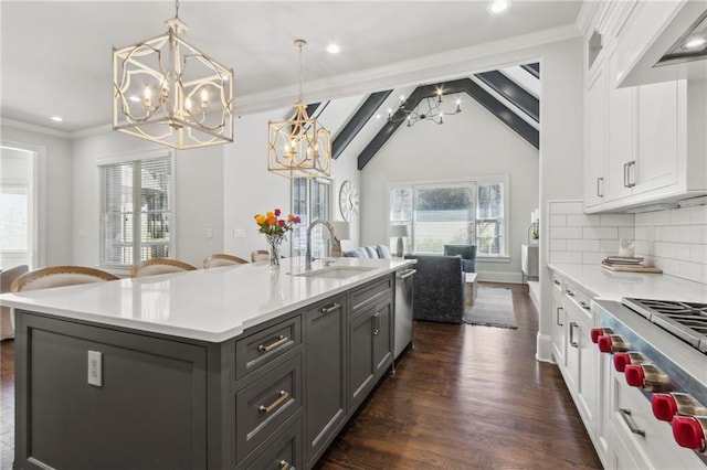 kitchen with a sink, white cabinetry, and a notable chandelier