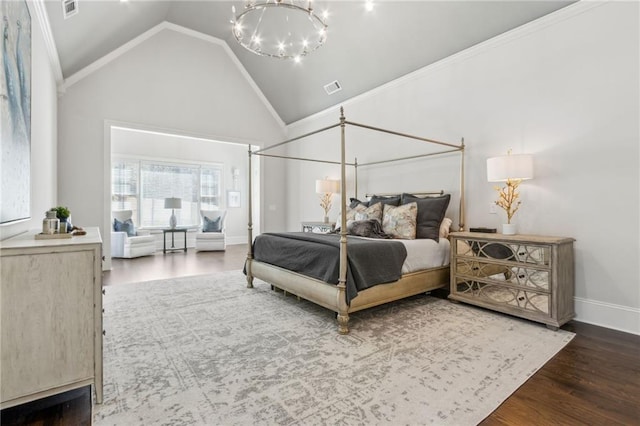 bedroom with an inviting chandelier, visible vents, wood finished floors, and baseboards