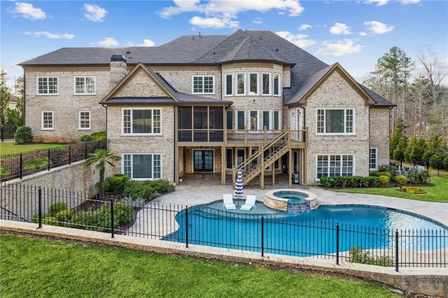 rear view of property with a sunroom, stairway, a fenced backyard, a patio area, and brick siding
