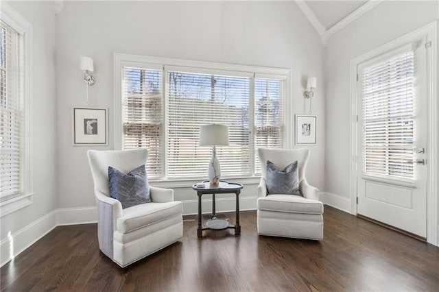 sitting room with plenty of natural light, lofted ceiling, and ornamental molding
