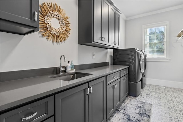 laundry room with baseboards, a sink, crown molding, separate washer and dryer, and cabinet space