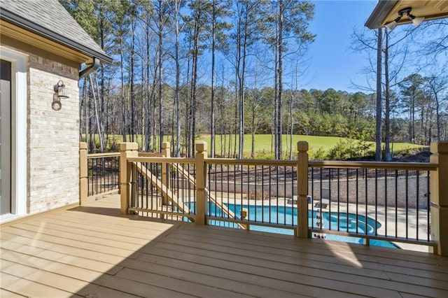 deck featuring a fenced in pool