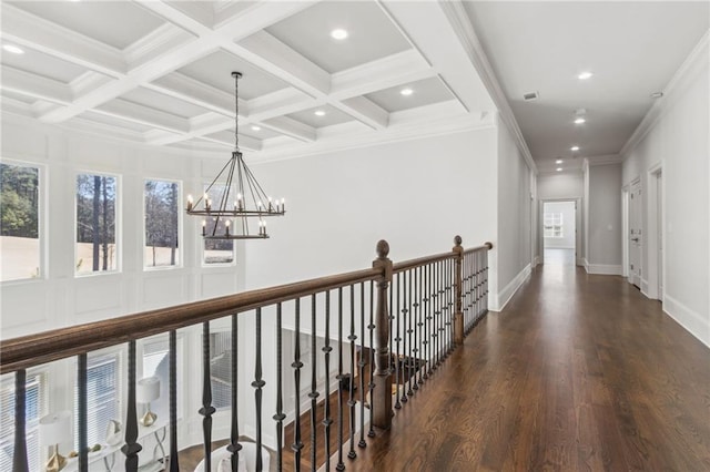 hall featuring a notable chandelier, beam ceiling, plenty of natural light, and wood finished floors