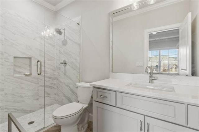 full bath with vanity, toilet, and a marble finish shower