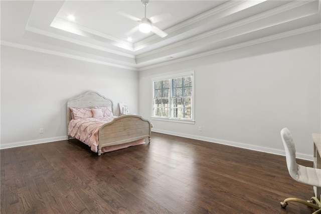 bedroom with crown molding, a raised ceiling, baseboards, and dark wood finished floors