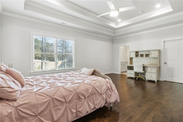 bedroom featuring a tray ceiling, crown molding, and dark wood-style floors