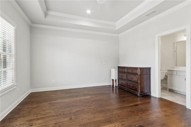 spare room with dark wood finished floors, baseboards, a raised ceiling, and ornamental molding